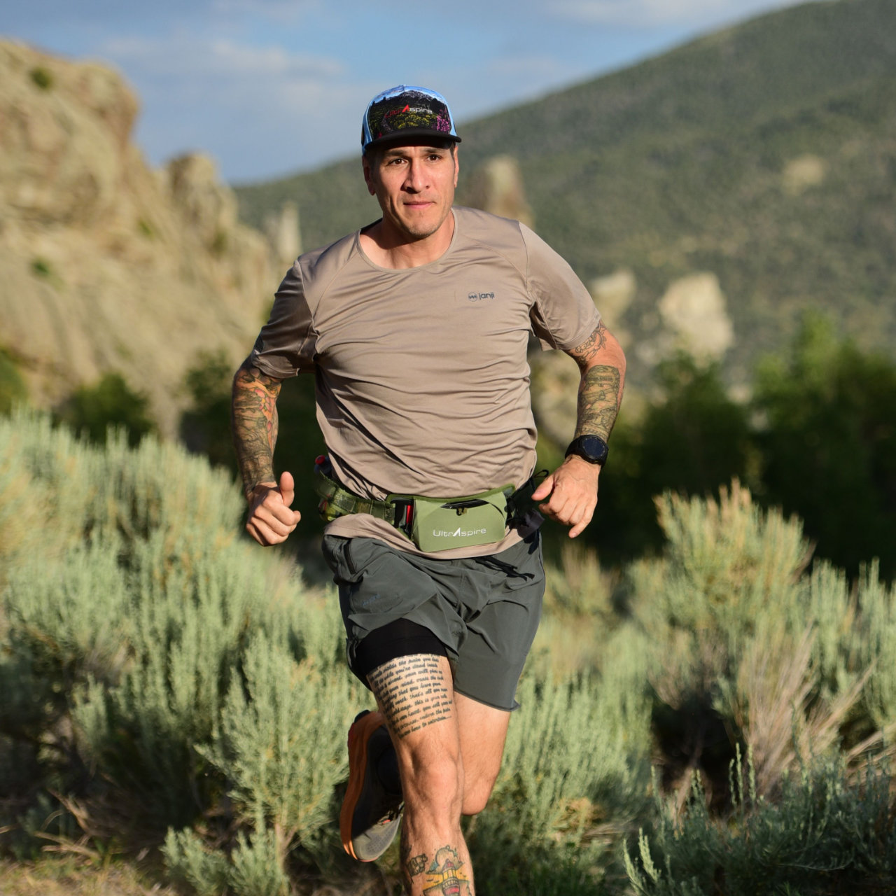 A running athlete wearing a Speedgoat 4.0 Waist Pack